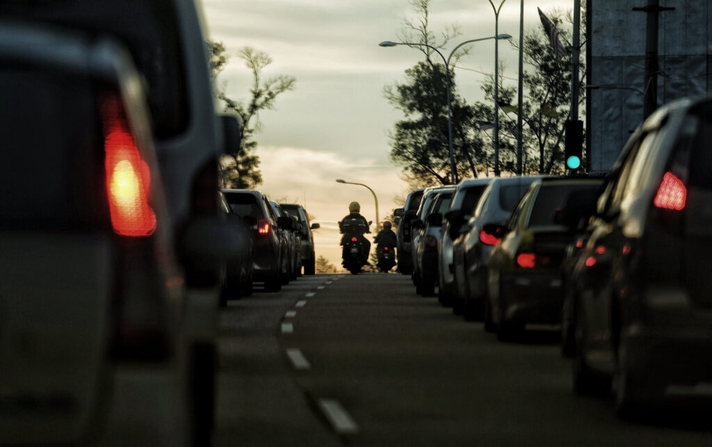 motorcyclist splitting lanes in traffic congestion
